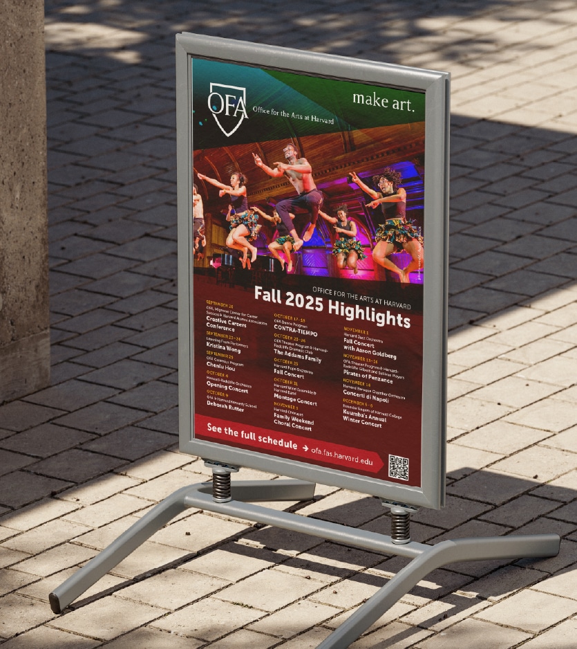 Event Poster in a frame standing on a brick sidewalk